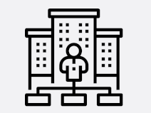 Das Icon stellt stellt drei Gebäude mit einer Person und einem Organigramm  dar